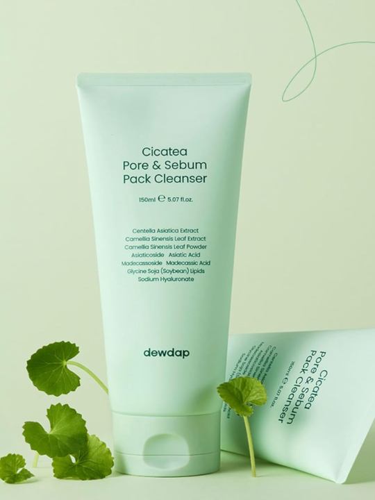 Tube of Dewdap Cicatea Pore & Sebum Pack Cleanser with green centella leaves on a light green background.