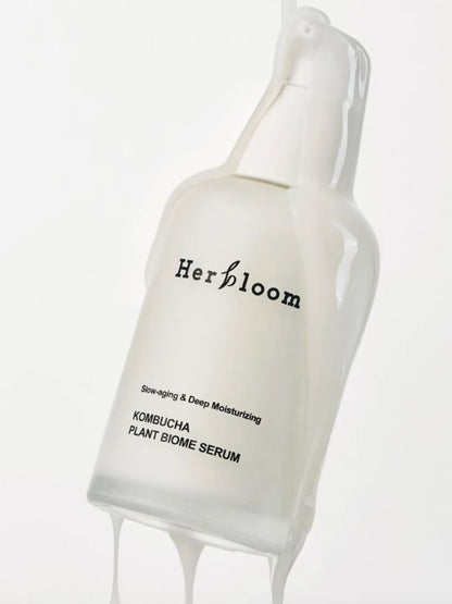 White cream running down a bottle of Herbloom Kombucha Plant Biome Serum on a white background