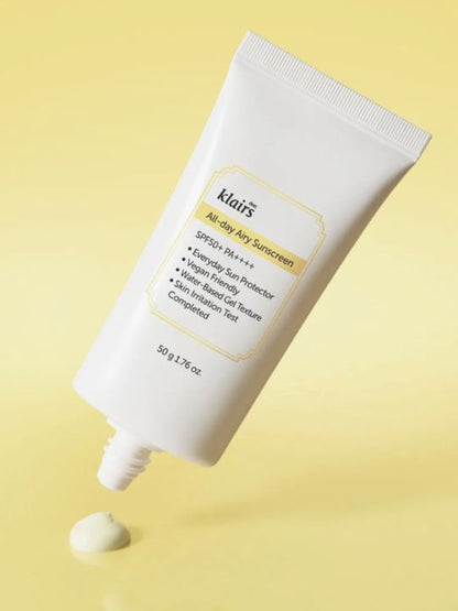 Klairs All Day Airy Sunscreen without a cap on a yellow background
