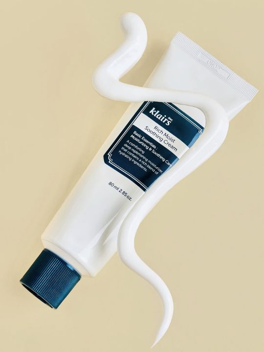 Klairs Rich Moist Soothing Cream with streak of white cream on a beige background