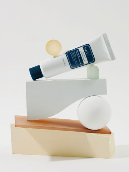 Klairs Rich Moist Soothing Cream lying on various geometric elements on a white background