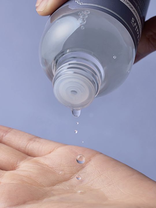 Klairs Supple Preparation Toner Unscented being poured onto someone's open palm, against a light purple background