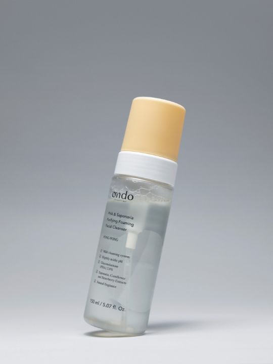 Bottle of Ondo Beauty 36.5 PHA & Saponaria Purifying Foaming Cleanser slightly tilted on a light grey background