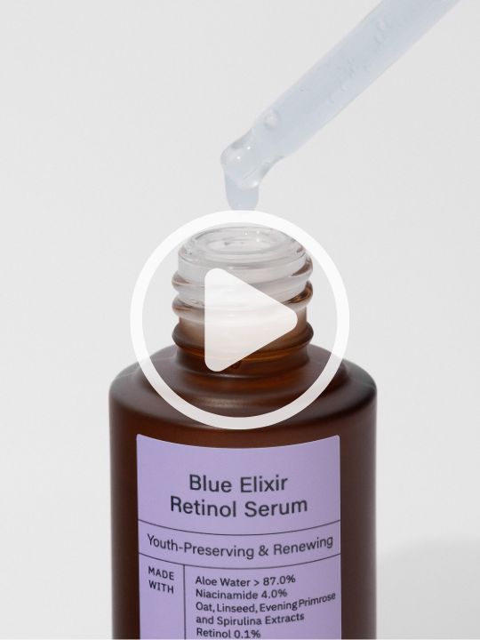 Meisani's Blue Elixir Retinol Serum being unboxed, against a pink background. 