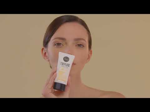 Model applying Suntique I'm Pure Perfect Cica sunscreen on a beige/yellow background