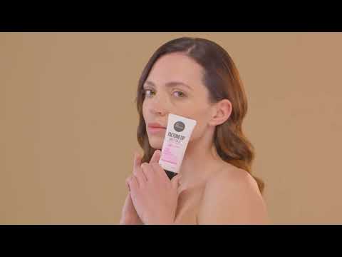 Woman applying Suntique I'm Tone Up Multibase Sunscreen on a yellow background