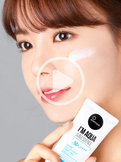Woman applying tube of Suntique I'm Aqua Sun Essence on a yellow background