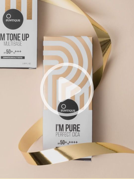 Suntique's I'm Pure Perfect Cica sunscreen is being applied to a model's hand.