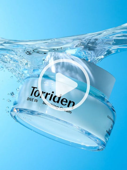 Woman showing jar of Torriden Dive In Soothing Cream against a blue background