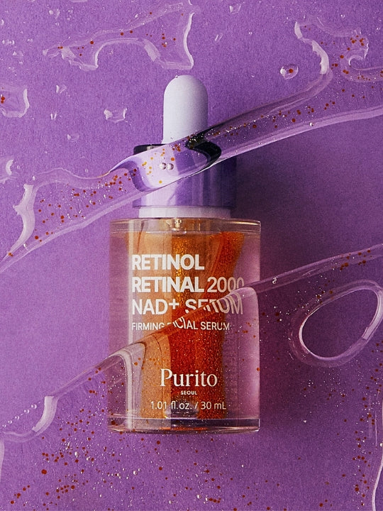 Purito Retinol Retinal 2000 NAD+ Serum in a clear dropper bottle with orange liquid inside, set against a purple background with decorative liquid swirls and glitter.