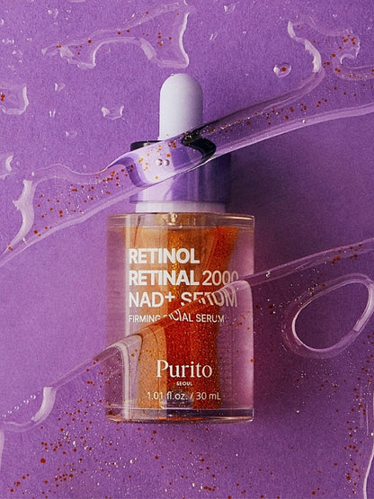 Purito Retinol Retinal 2000 NAD+ Serum in a clear dropper bottle with orange liquid inside, set against a purple background with decorative liquid swirls and glitter.