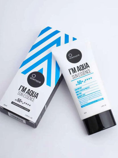 Suntique I'm Aqua Sun Essence tube and box on a light grey background