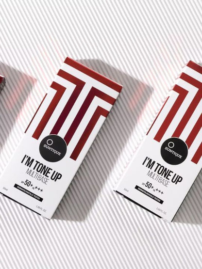 Suntique I'm Tone Up Multibase Sunscreen boxes on a striped background