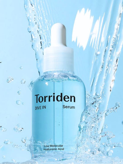 Torriden Dive In Low Molecular Hyaluronic Acid Serum bottle with water droplets on a blue background