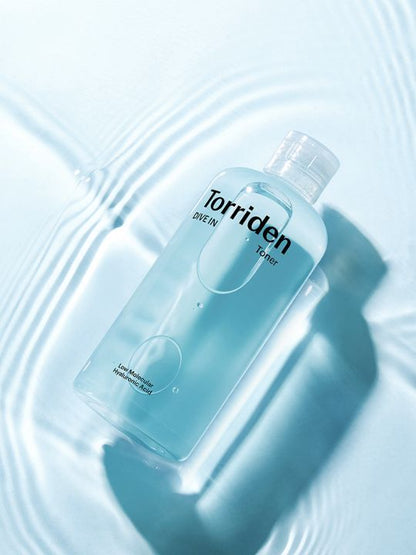Torriden Dive In Toner bottle on a light blue watery background