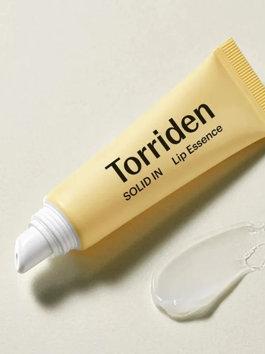 Tube of Torriden Solid In Lip Essence without a cap and with a swatch of cream on a pale background