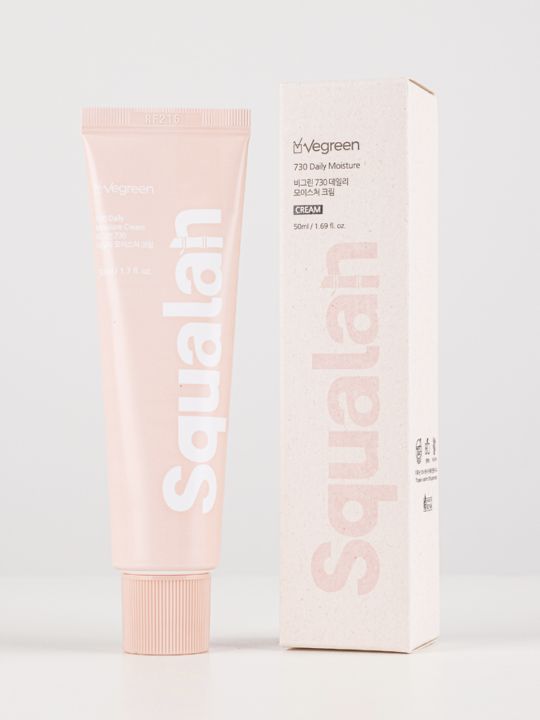 Tube of Vegreen 730 Daily Moisture Cream standing next to its retail box on a light grey background