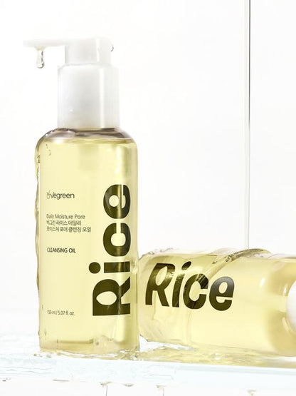 Two pump bottles of Vegreen Rice Daily Moisture Pore Cleansing Oil with liquid running down on a white background