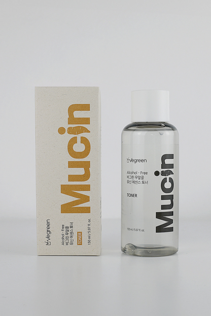 Vegreen's Nature Mucin Essence Toner bottle and box standing against a light grey background.